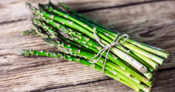 istock Green Asparagus on vintage background. 813369924