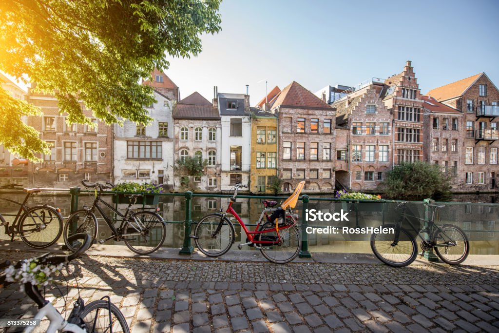 Gent city in Belgium Riverside view with beautiful old buildings and bicycles during the morning light in Gent city, Belgium Ghent - Belgium Stock Photo