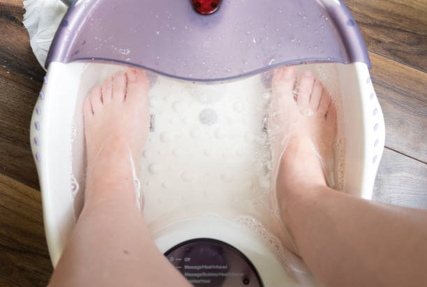 istock two feet pampering pedicure wash in a specialized foot Spa with massage effect 813376112