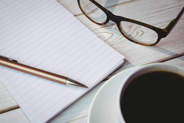 istock Empty notepad with reading glasses and cup of coffee 813385488
