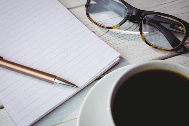 istock Empty notepad with reading glasses and cup of coffee 813385524