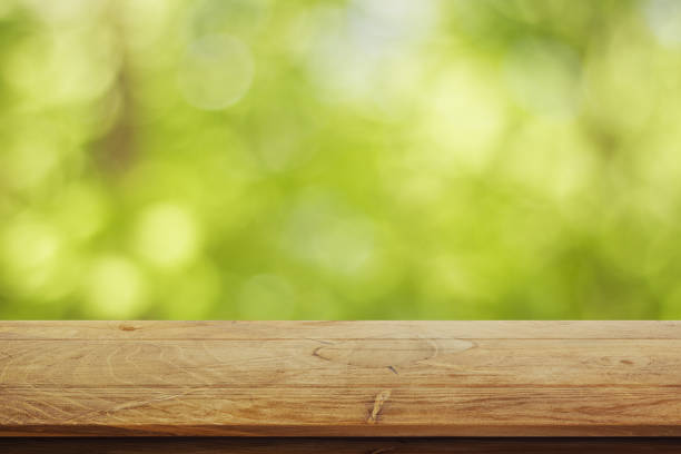 istock Wooden surface on green background 813388454