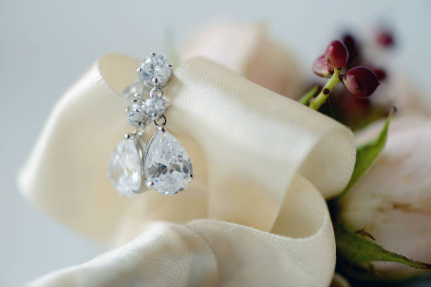 Earrings lie on the bed linen