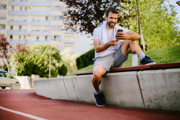 istock Handsome young man choosing music for running 813402220