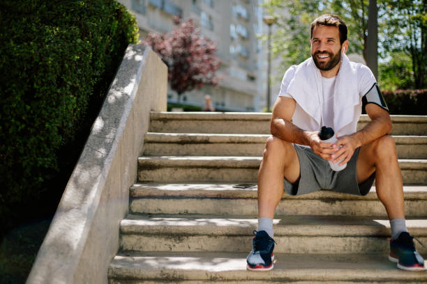 istock Young man siitting at stairs and smiling 813404688