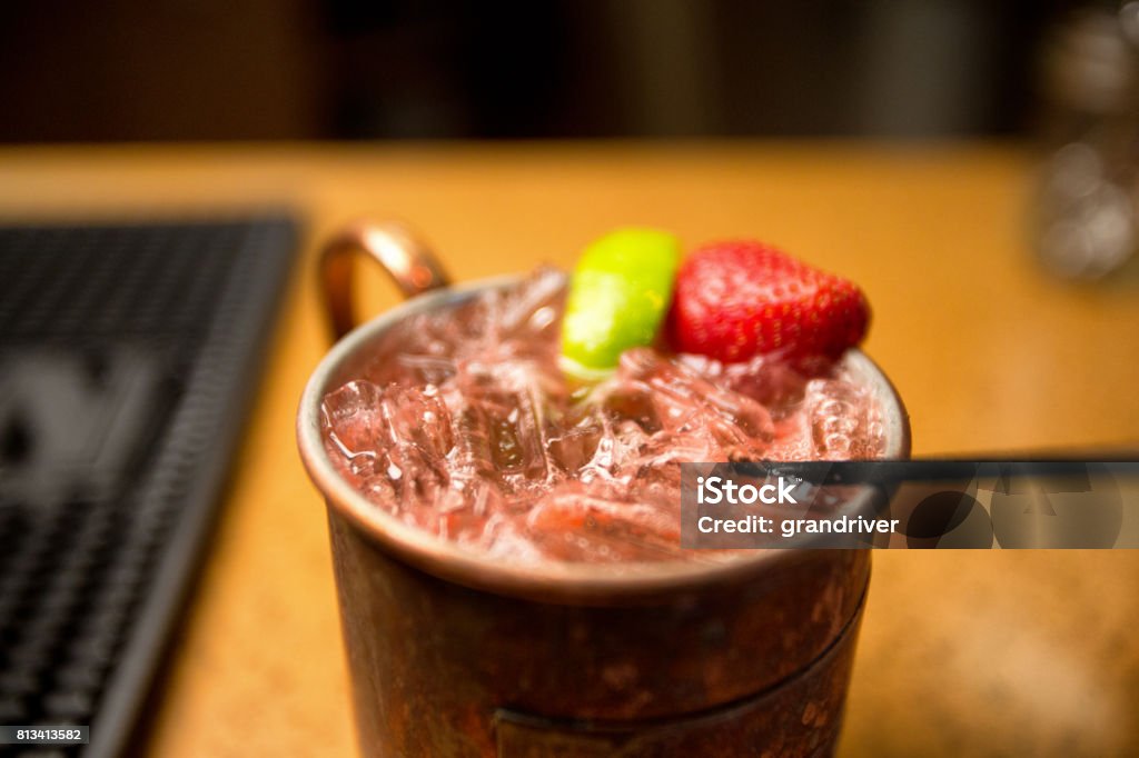 Vodka Moscow Mule with Lime and Strawberry A Moscow Mule Cocktail with Vodka, lime and strawberry in a copper mug Moscow Mule Stock Photo