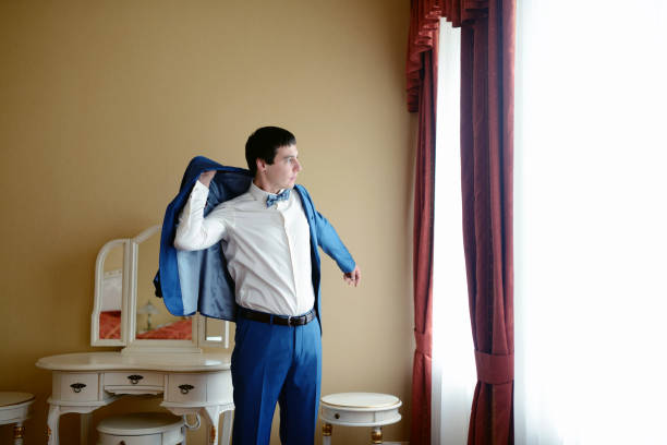 istock Groom is wearing a suit indoors 813416192