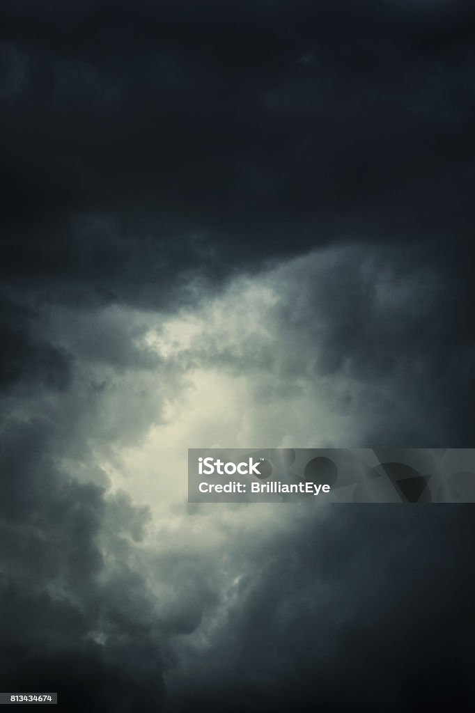 epic clouds with bright spot in the middle Dramatic Sky Stock Photo