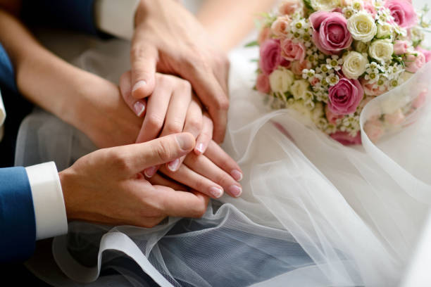 istock Wedding couple is holding hands 813434790