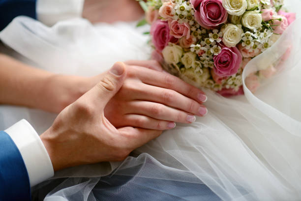 istock Wedding couple is holding hands 813434836