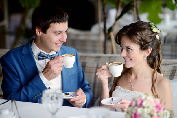 istock Wedding couple indoors is drinking coffee 813436908
