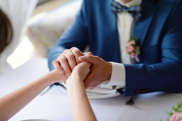 istock Wedding couple is holding hands 813437160