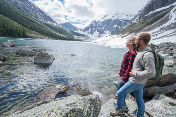 istock Couple hiking by mountain lake 813439650