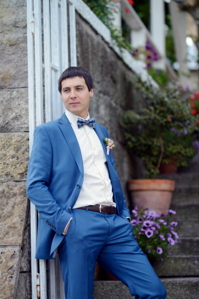istock Handsome groom in suit on the nature 813442062