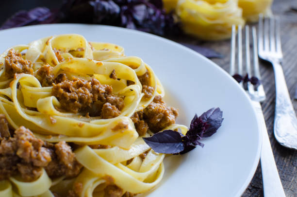 istock Pasta with bolognese sauce on wooden background 813452066