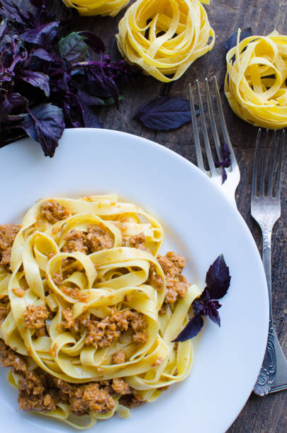 istock Pasta with bolognese sauce on wooden background 813452068