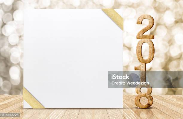 Happy New Year 2018 With Blank White Greeting Card With Gold Ribbon In Perspective Room At Sparkling Bokeh Wall And Wooden Plank Floor Leave Space For Display Of Design Stock Photo - Download Image Now