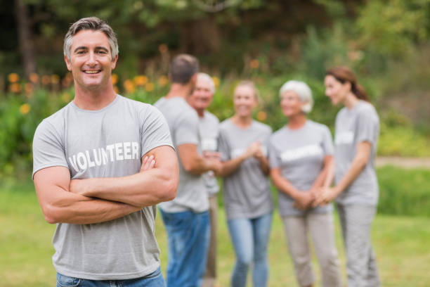 istock Happy volunteer looking at camera with arms crossed 813455296