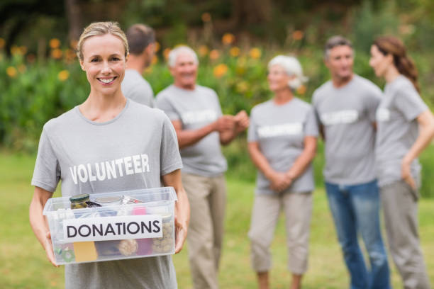 istock Happy volunteer holding donation box 813455620