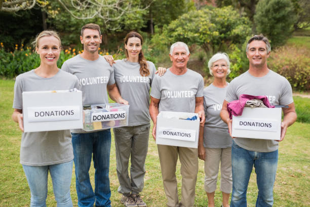 istock Happy volunteer family holding donations boxes 813460314