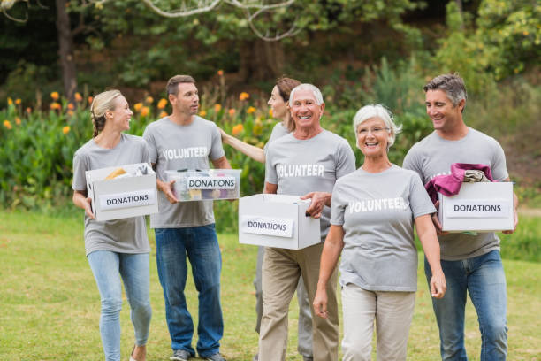 istock Happy volunteer family holding donations boxes 813460364