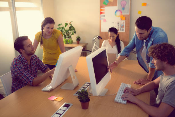 istock Attentive business team working on laptops 813460468