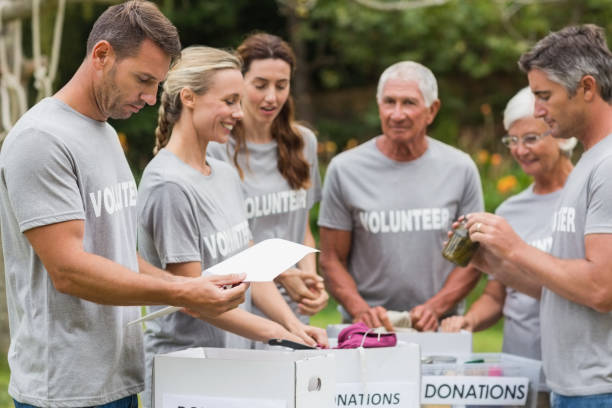 istock Happy volunteer looking at donation box 813460616