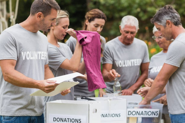 istock Happy volunteer looking at donation box 813460714