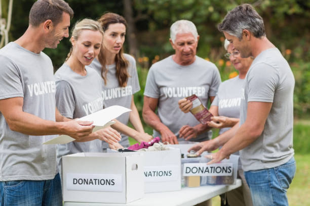 istock Happy volunteer looking at donation box 813460782