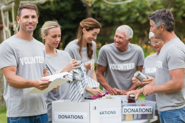 istock Happy volunteer looking at donation box 813460852