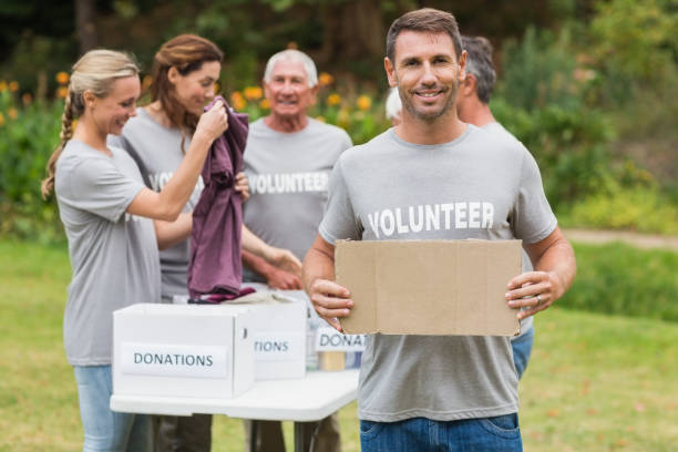 istock Happy volunteer family holding donation boxes 813460910