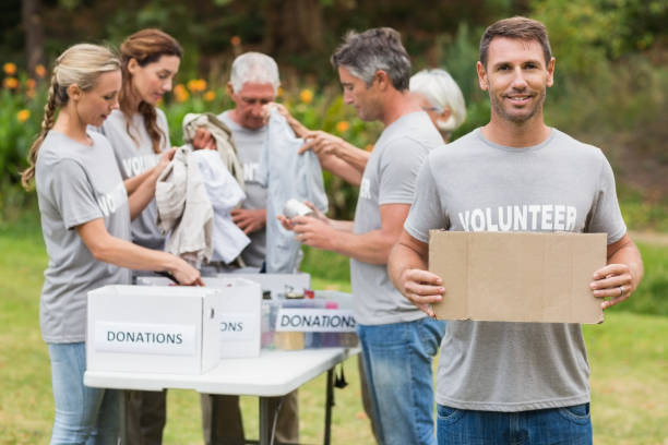 istock Happy volunteer family holding donation boxes 813461014