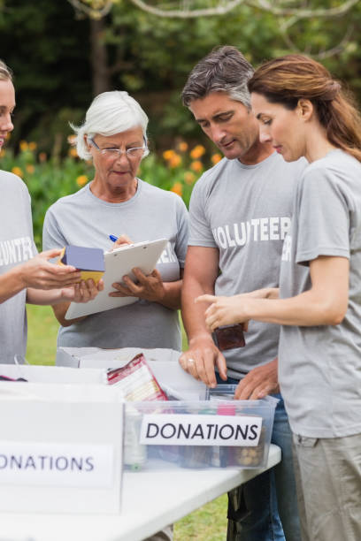 istock Happy volunteer looking at donation box 813461160