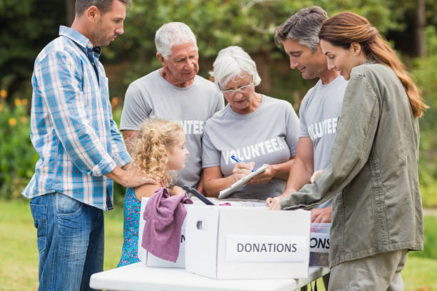 istock Happy volunteer family separating donations stuffs 813463426