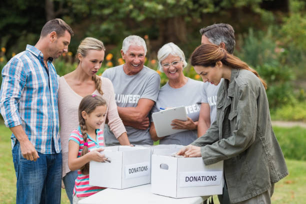 istock Happy volunteer family separating donations stuffs 813463592