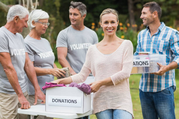 istock Happy volunteer family separating donations stuffs 813463640