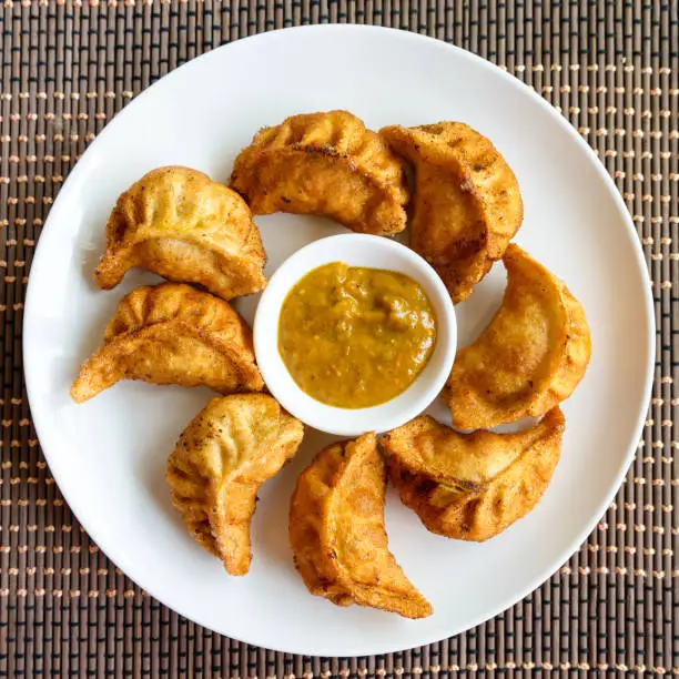 Plate of fried Nepalese momos and its achar (sauce)