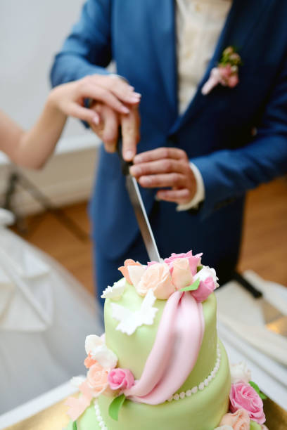 istock Beauty bride and handsome groom are cutting a wedding cake 813468908