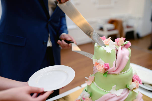 istock Beauty bride and handsome groom are cutting a wedding cake 813469000