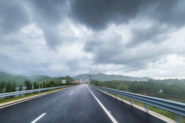 istock highway in motion blur under cloudy day with heavy rain in summer 813469094
