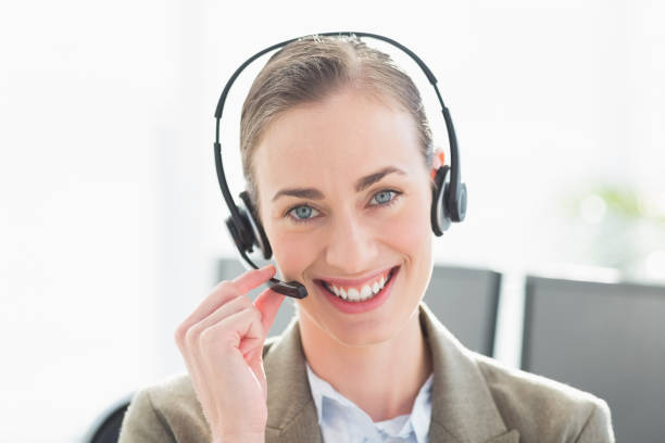 istock Smiling businesswoman with headset looking at camera 813507502