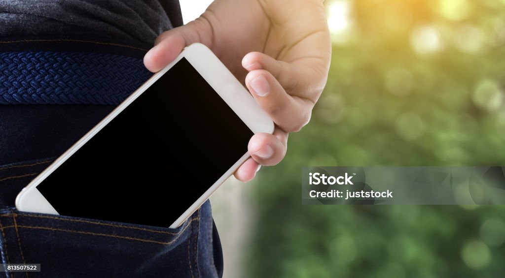 Young handsome poses hand Mobile Phone Pocket Communication Copy Space Pocket Stock Photo