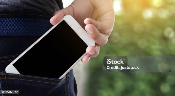 Young Handsome Poses Hand Mobile Phone Pocket Communication Copy Space Stock Photo - Download Image Now