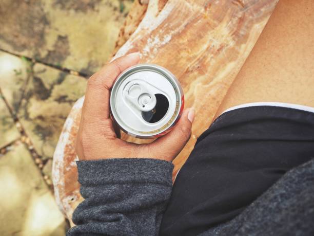 istock Woman drinking cola can with leg 813510422