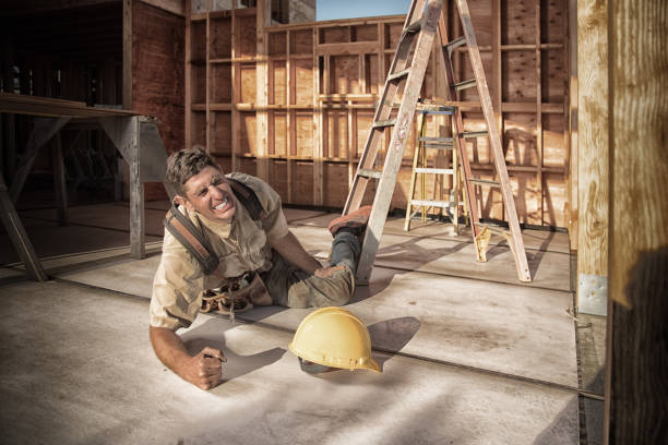 Home Building - Injury Carpenter building a home at construction site. Falling off ladder. Injured leg. construction worker injured stock pictures, royalty-free photos & images