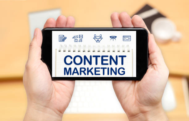istock Watching two hand holding mobile phone with Content marketing word on screen and blur desk office background,Digital content concept 813523224