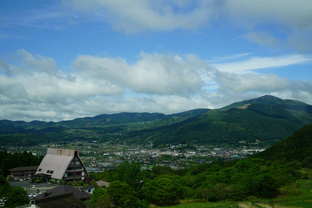 istock Lush greenery mountain landscape panorama and town view 813525844