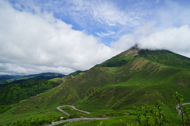 istock Greenery landscape panorama of Mount Yufu summit with white cloudy sky 813525870