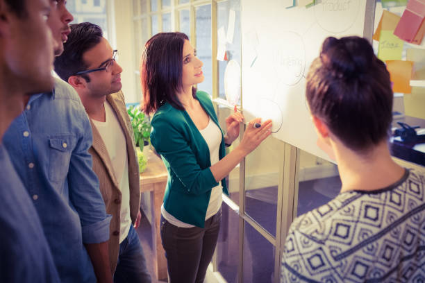 istock Young colleagues in discussion at office 813533136