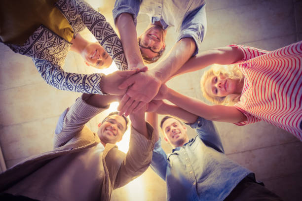 istock Happy business team joining their hands 813533312